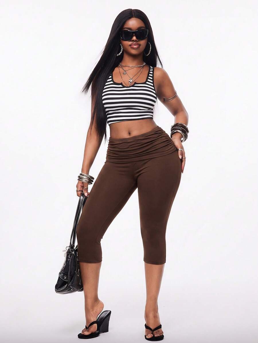 Women's polka dot cropped capri pants in a black and white geometric pattern with an elastic drawstring waist and skinny fit.