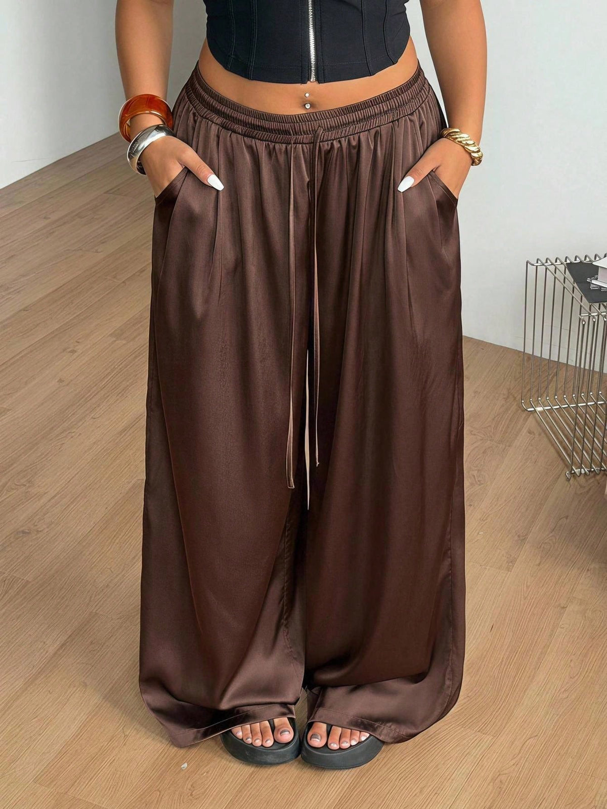 Women's loose straight leg cotton pants featuring a high waist with an adjustable drawstring knot and functional side pockets.