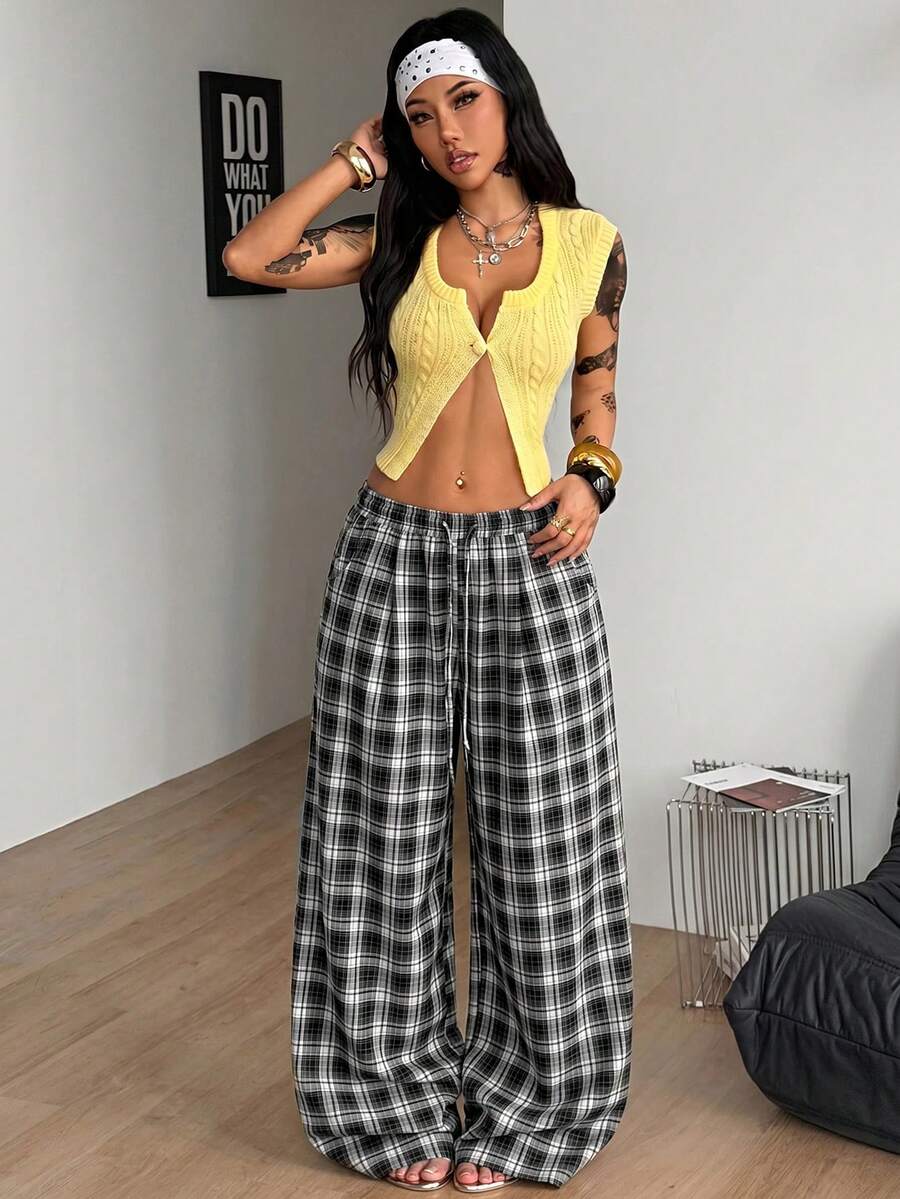 Women's loose fit brown and tan plaid wide leg pants featuring an elastic drawstring waist and side pockets.