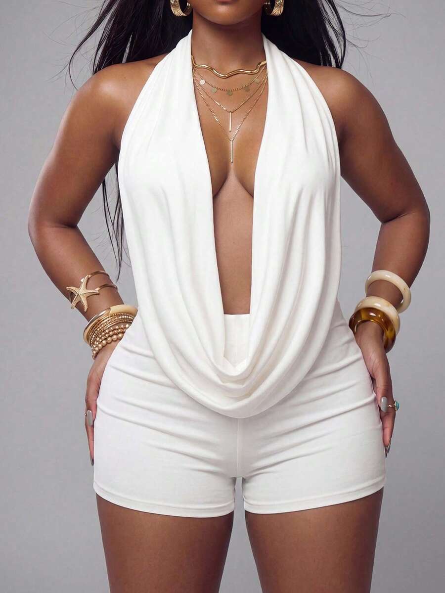Front and back view of a women's white backless halter romper featuring a draped cowl neckline and fitted short unitard design.