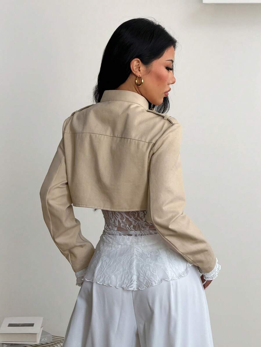 Women's khaki cropped military jacket featuring decorative Napoleon trim, long regular sleeves, tie neck, grommet eyelets, and single-breasted front closure.