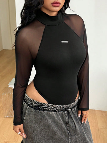 Women's black long sleeve bodysuit with sheer contrast lace raglan sleeves and stand collar.