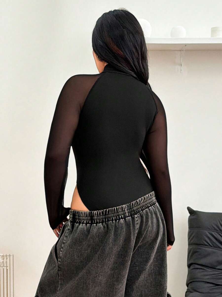 Women's black long sleeve bodysuit with sheer contrast lace raglan sleeves and stand collar.