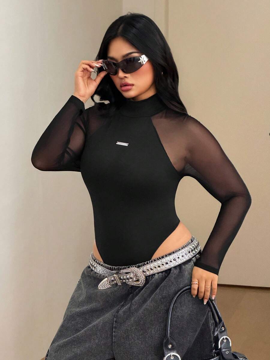 Women's black long sleeve bodysuit with sheer contrast lace raglan sleeves and stand collar.