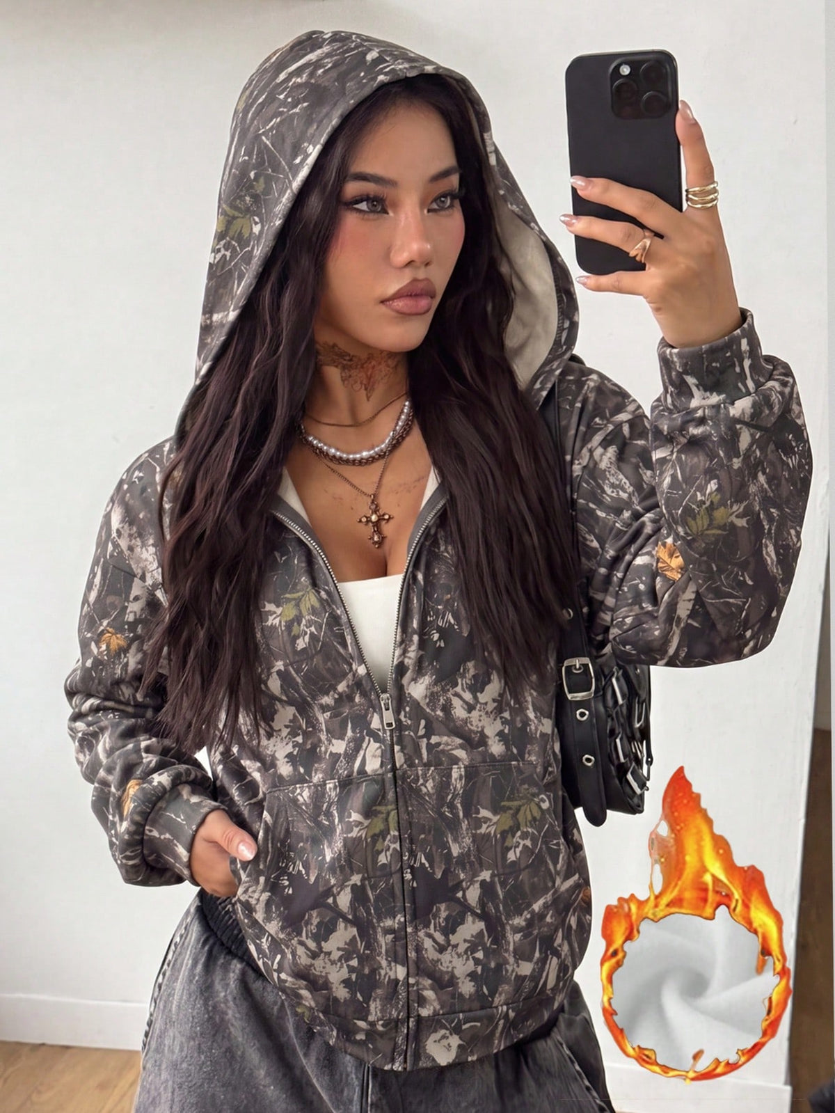 Women's army green camo zip up hoodie with drop shoulder sleeves, front pockets, and drawstring hood