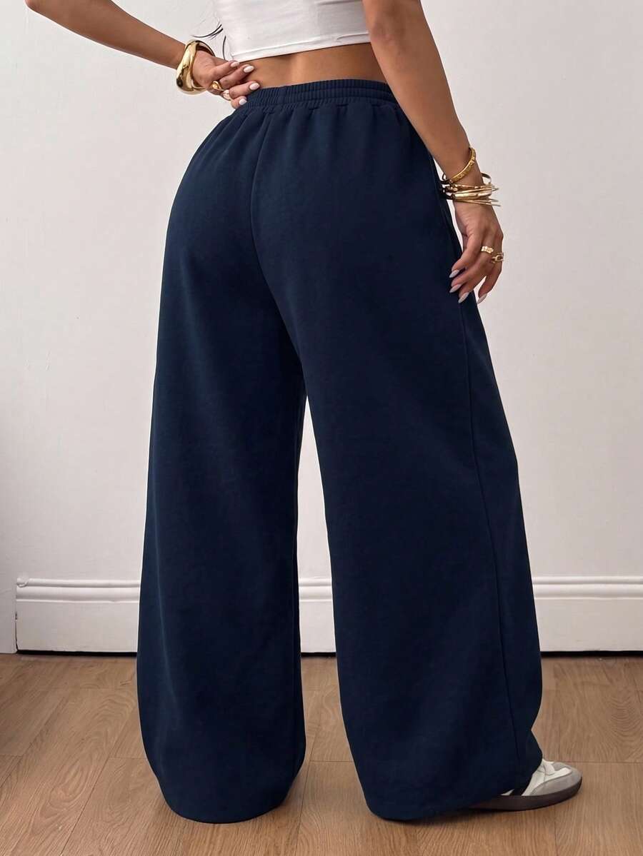 Women's loose wide leg casual sweatpants with an elastic waistband and side pockets