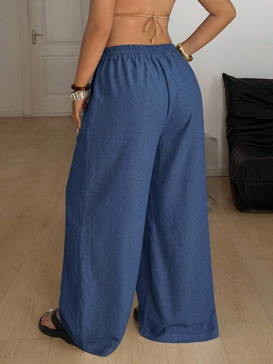 Women's loose straight leg cotton pants featuring a high waist with an adjustable drawstring knot and functional side pockets.