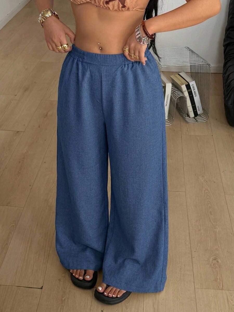 Women's loose straight leg cotton pants featuring a high waist with an adjustable drawstring knot and functional side pockets.
