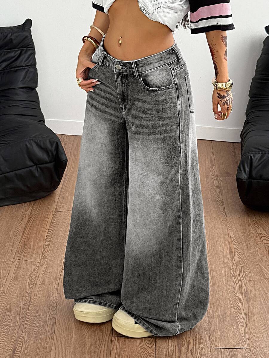 Loose wide leg denim jeans for women featuring a low waist, functional pockets, zipper fly closure, and extra long relaxed fit.