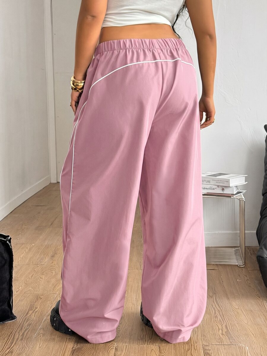 Plus size loose straight leg casual pants with elastic drawstring waist, contrast binding, and side pockets.