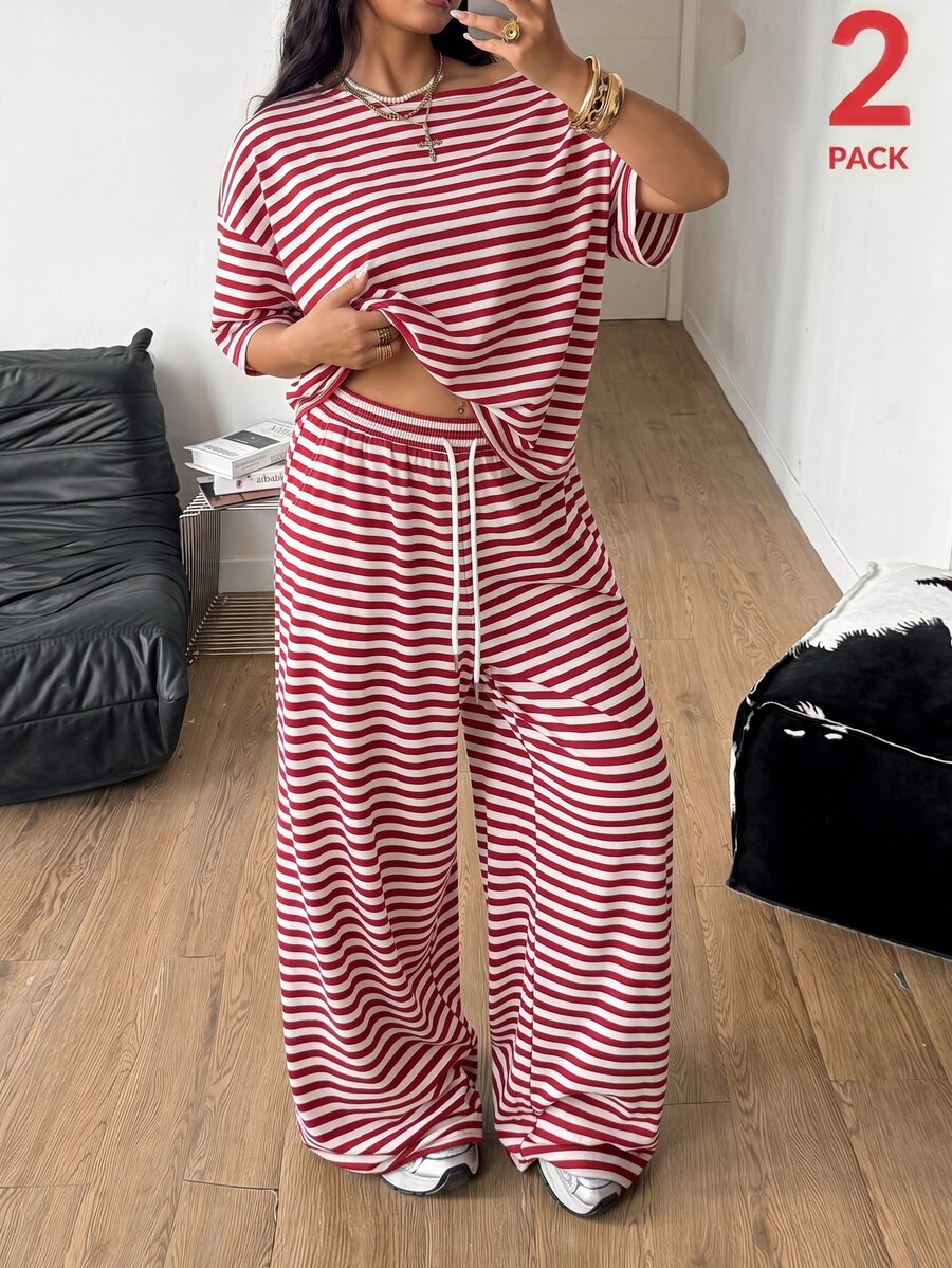 Women's casual two-piece outfit featuring a loose short-sleeve asymmetrical neck t-shirt and matching long wide leg pants with pockets.