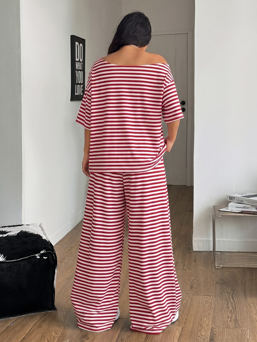 Women's casual two-piece outfit featuring a loose short-sleeve asymmetrical neck t-shirt and matching long wide leg pants with pockets.