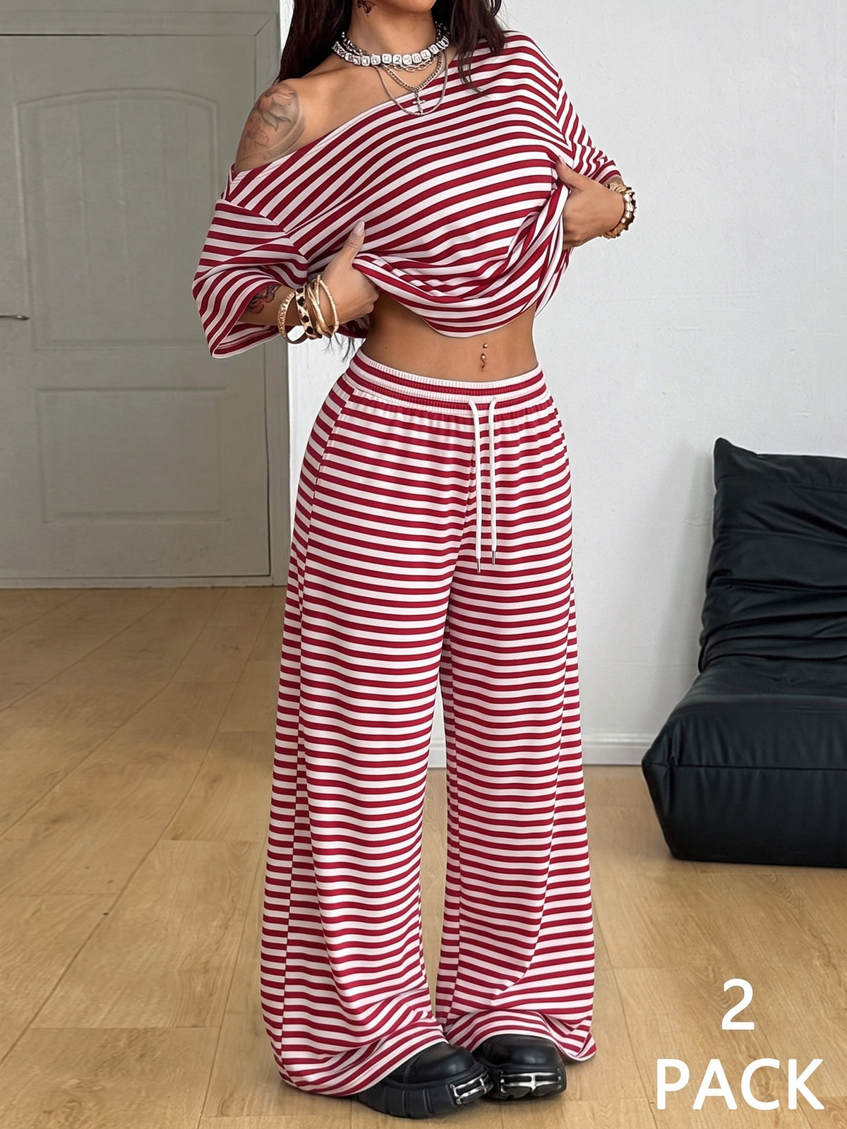 Women's casual two-piece outfit featuring a loose short-sleeve asymmetrical neck t-shirt and matching long wide leg pants with pockets.