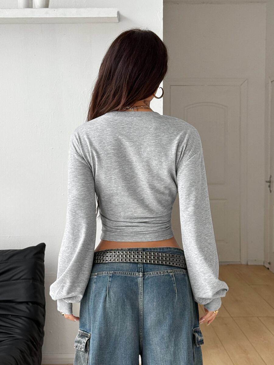 Women's brown waist-cinching sweatshirt featuring a round neck, drop shoulder long sleeves, and rib-knit cuffs.