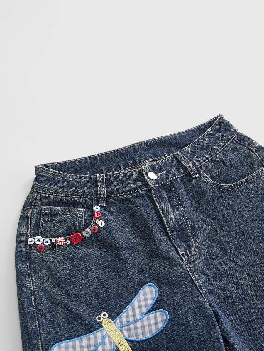 Women's loose baggy blue denim jeans featuring embroidered dragonfly and ladybug patch appliques, front pockets, and a straight-leg cut.