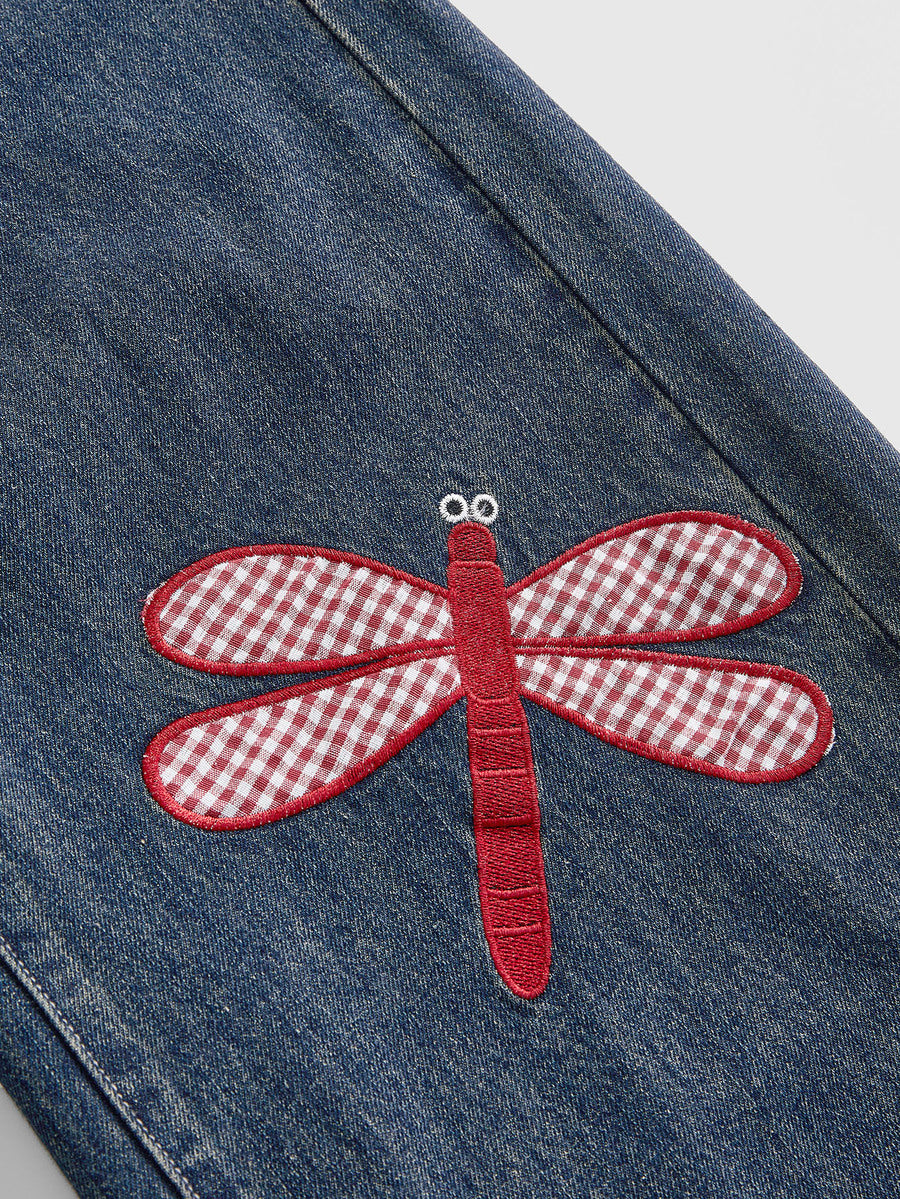 Women's loose baggy blue denim jeans featuring embroidered dragonfly and ladybug patch appliques, front pockets, and a straight-leg cut.