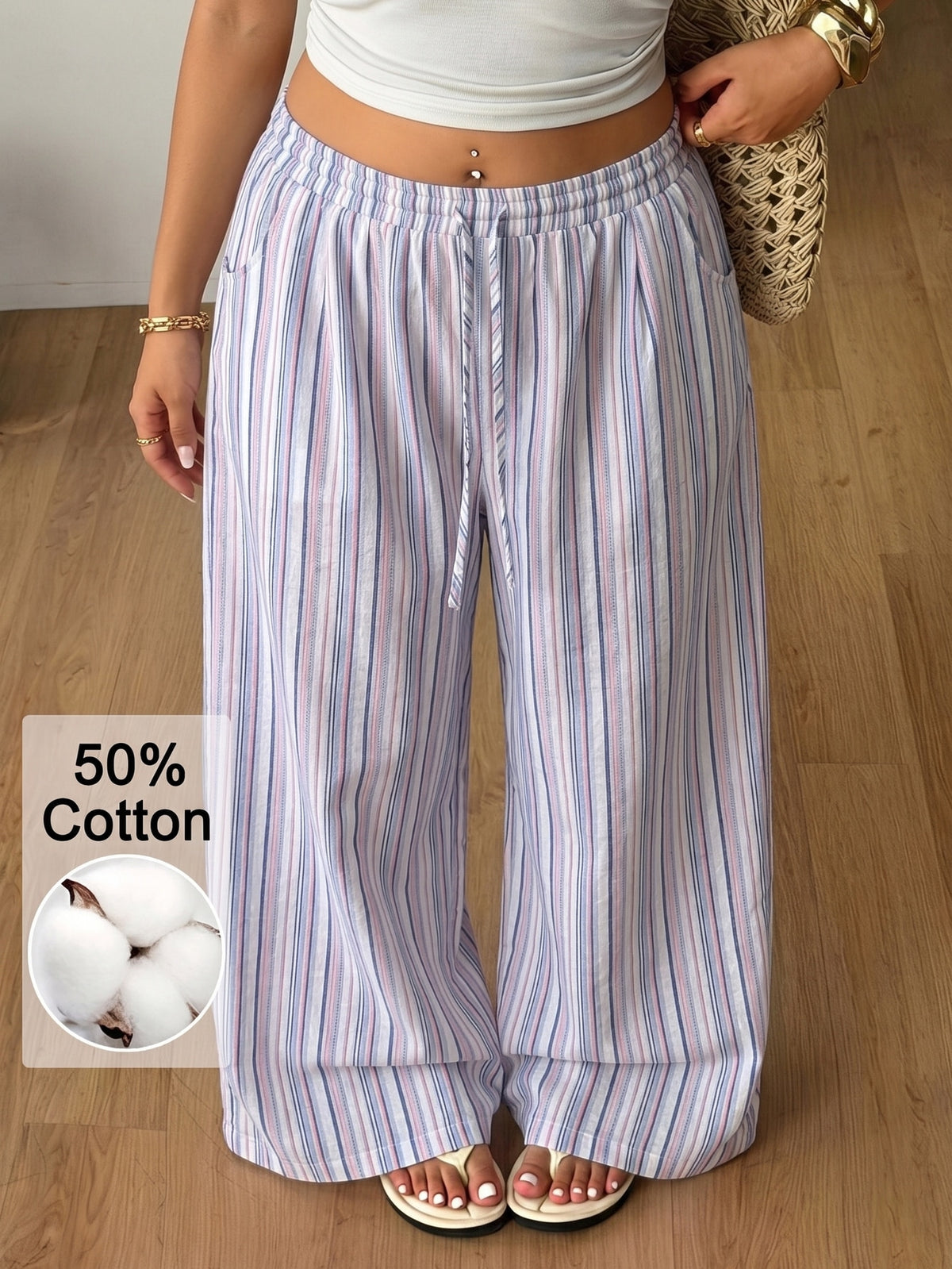 Women's loose straight leg cotton pants featuring a high waist with an adjustable drawstring knot and functional side pockets.