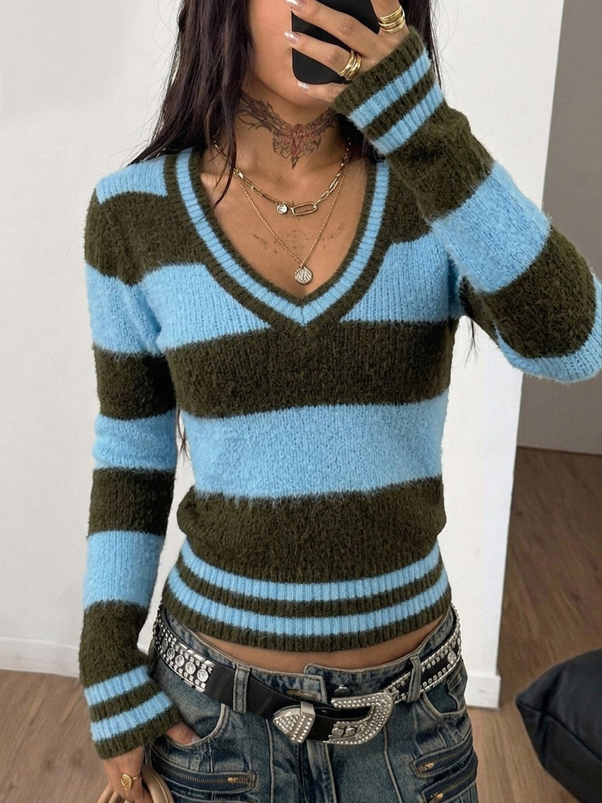Women's slim fit cable-knit sweater with a V-neckline and long sleeves in solid green rib knit fabric.