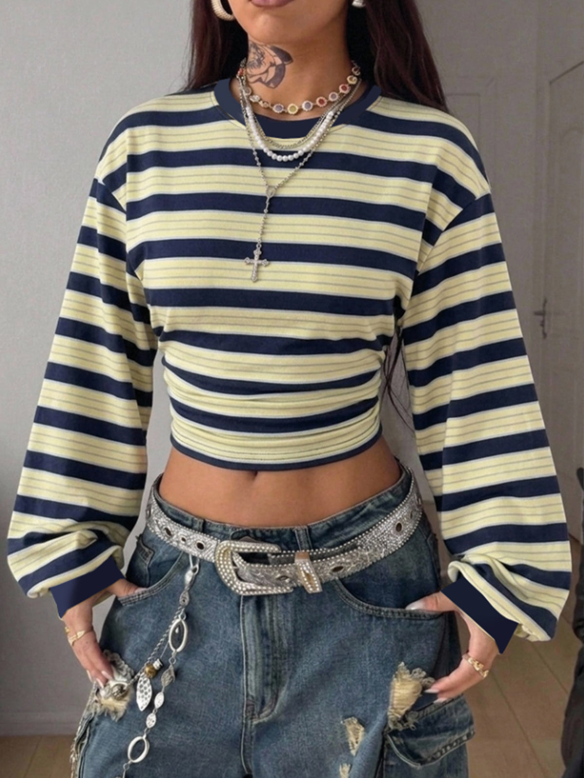 Women's striped pullover sweatshirt featuring drop shoulder long sleeves and a classic round neckline.