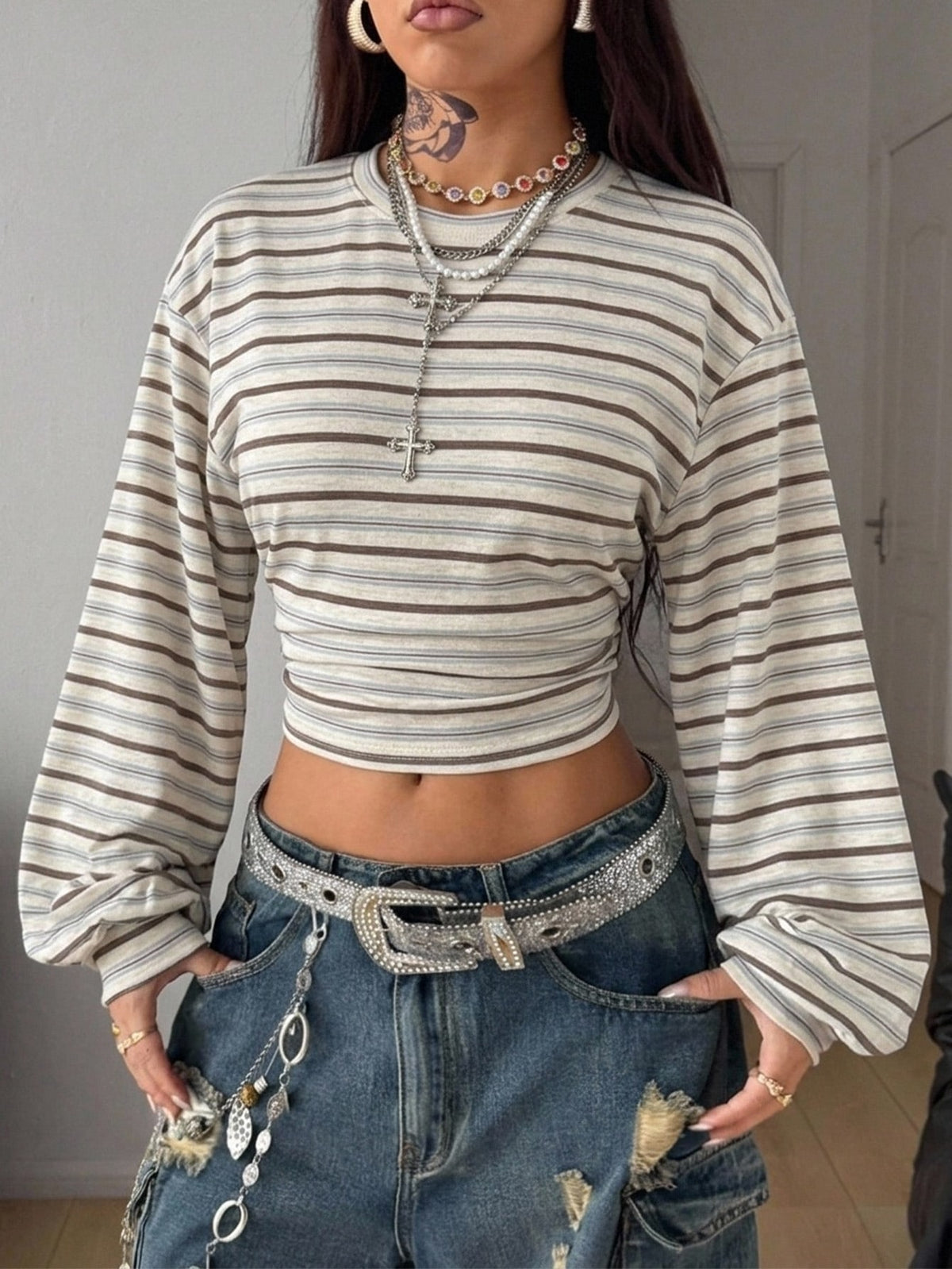 Women's striped pullover sweatshirt featuring drop shoulder long sleeves and a classic round neckline.