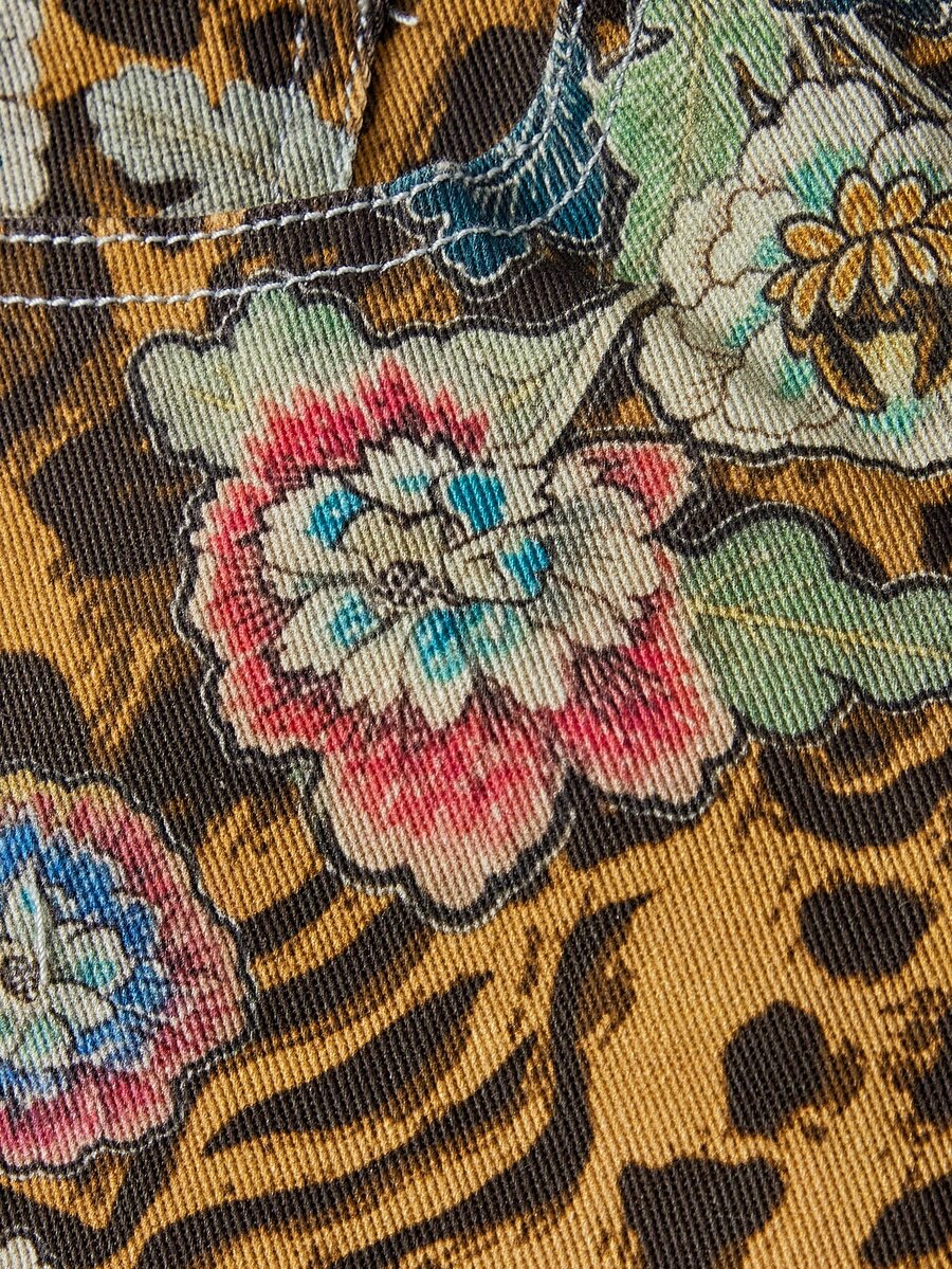 Women's leopard and floral print denim capri jeans featuring an ultra low waist and zipper fly closure.