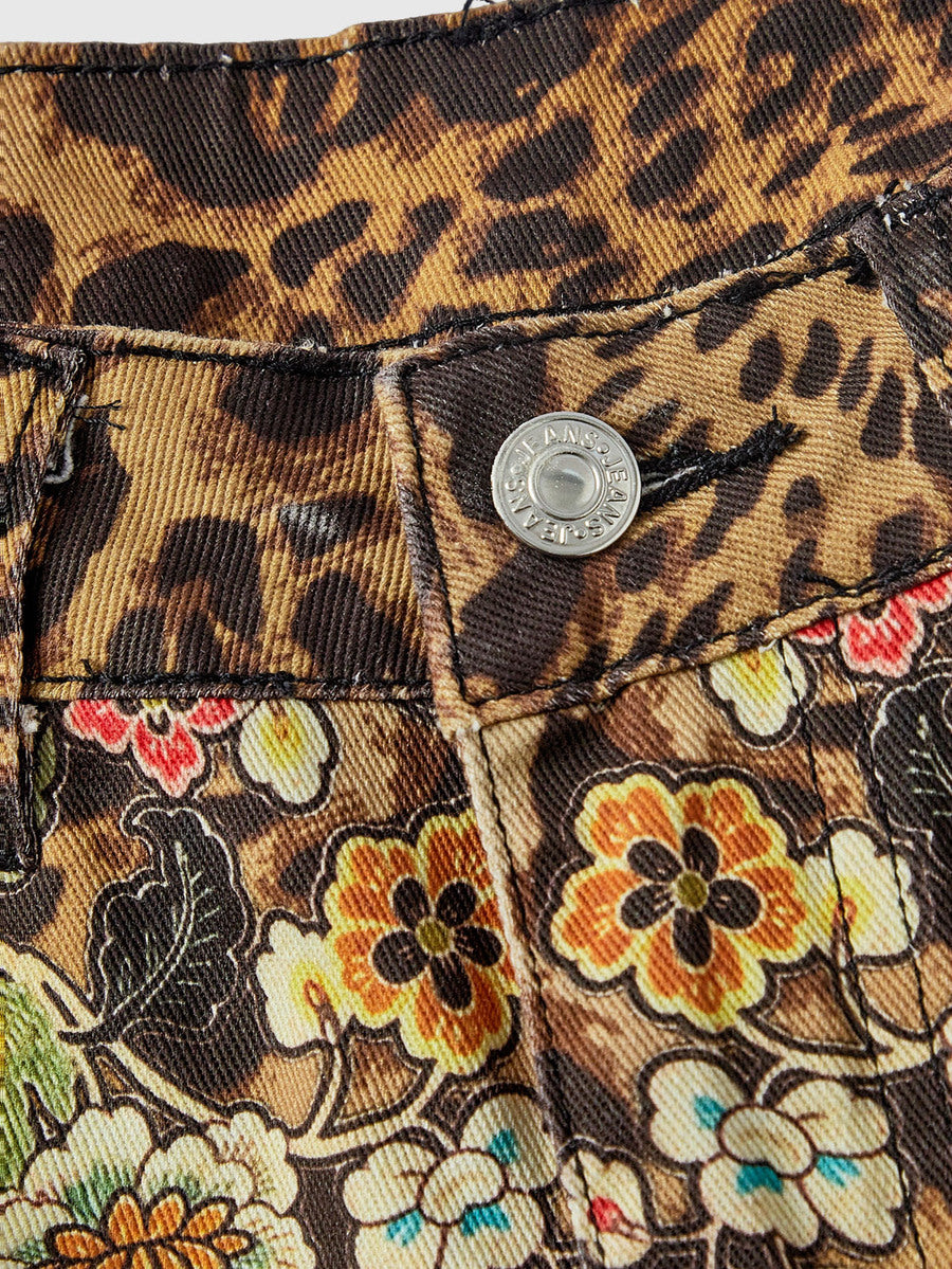 Women's leopard and floral print denim capri jeans featuring an ultra low waist and zipper fly closure.