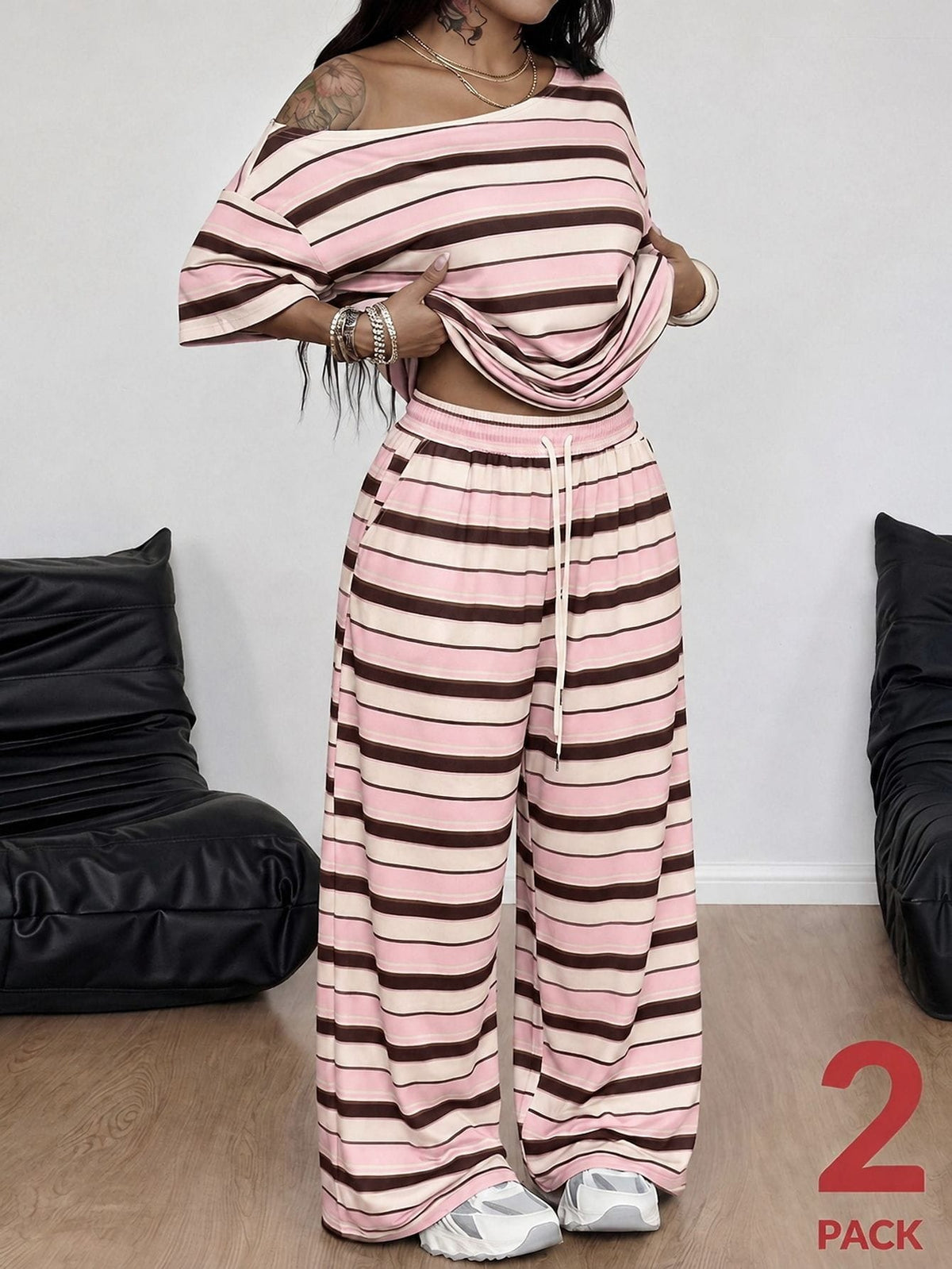 Striped two-piece casual outfit featuring an asymmetrical off-shoulder short-sleeve top and matching loose wide-leg pants with side pockets.