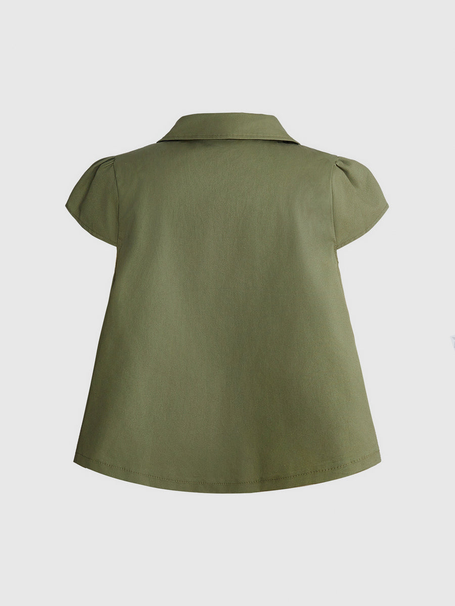 Women's short puff sleeve cotton blouse featuring a Peter Pan collar, double button detail, and front pocket.