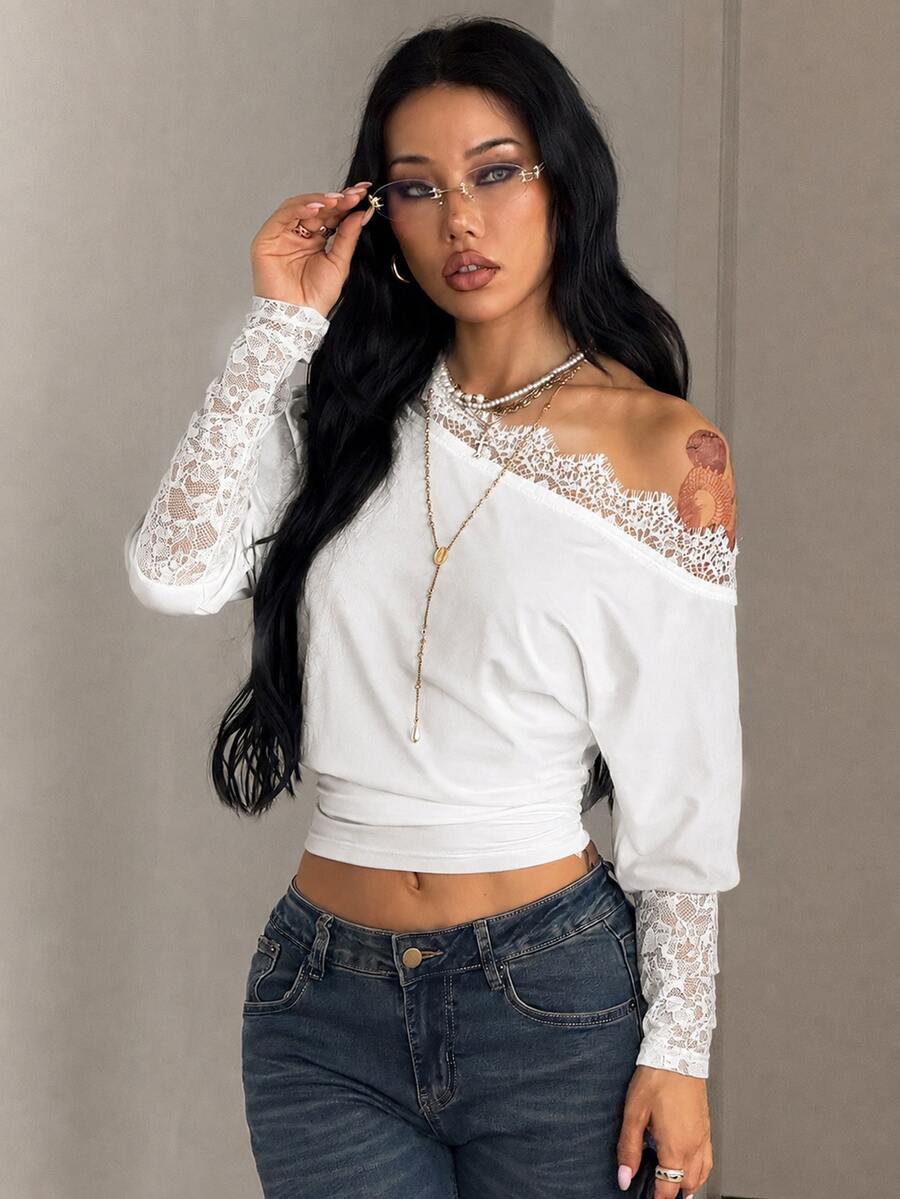 Women's black long sleeve t-shirt featuring delicate contrast lace details and a boat neckline in a knitted stretch fabric.