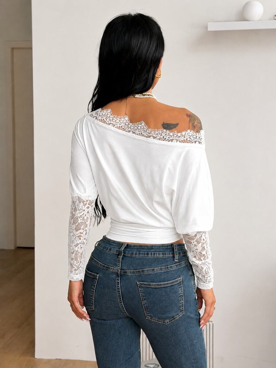 Women's black long sleeve t-shirt featuring delicate contrast lace details and a boat neckline in a knitted stretch fabric.