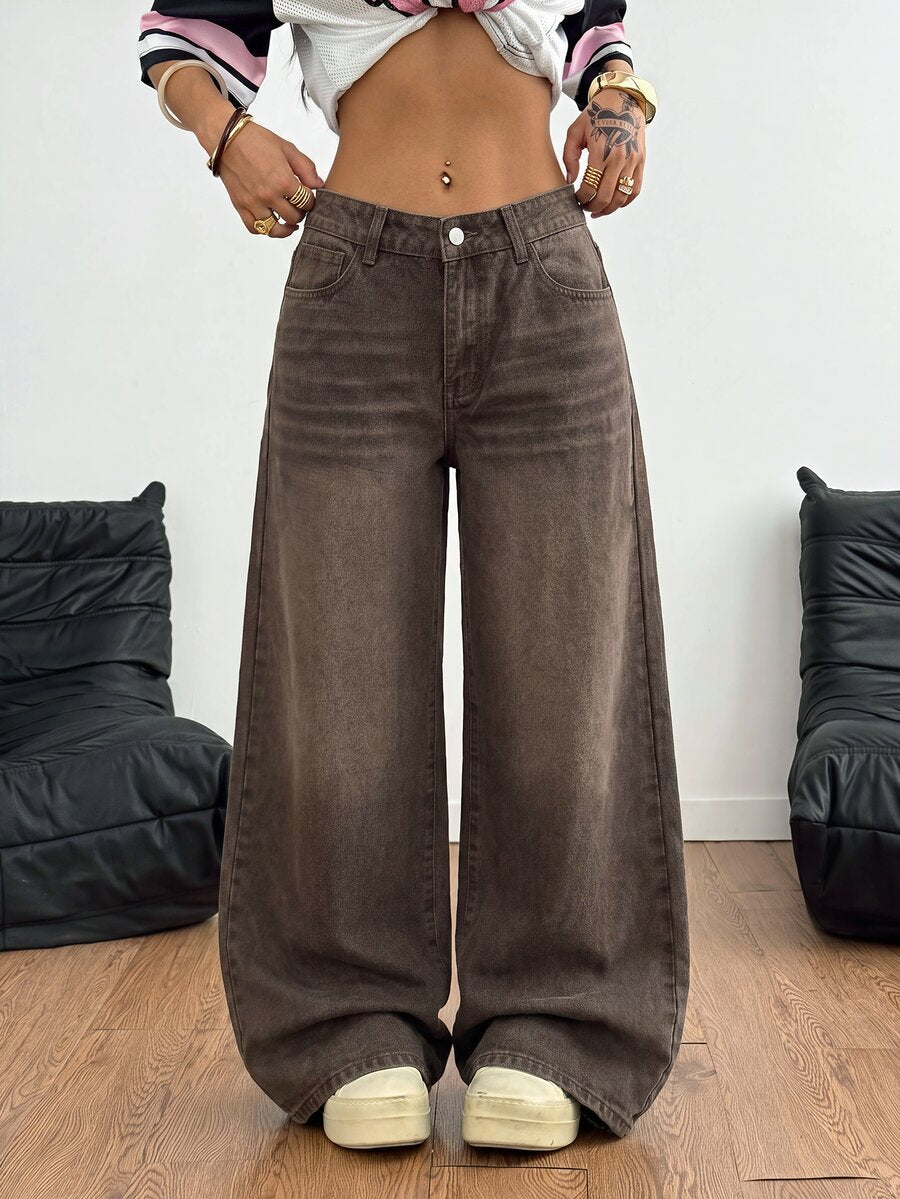 Loose wide leg denim jeans for women featuring a low waist, functional pockets, zipper fly closure, and extra long relaxed fit.