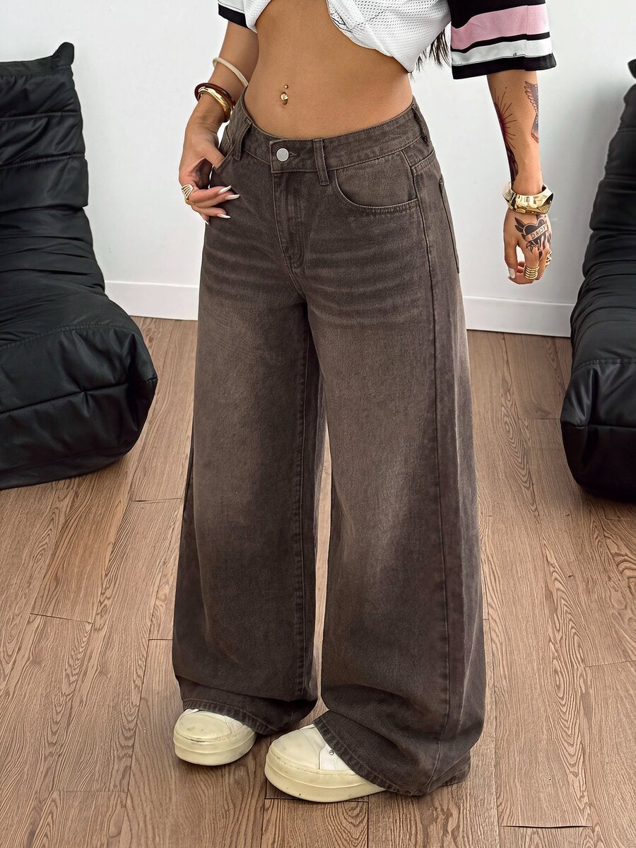 Loose wide leg denim jeans for women featuring a low waist, functional pockets, zipper fly closure, and extra long relaxed fit.
