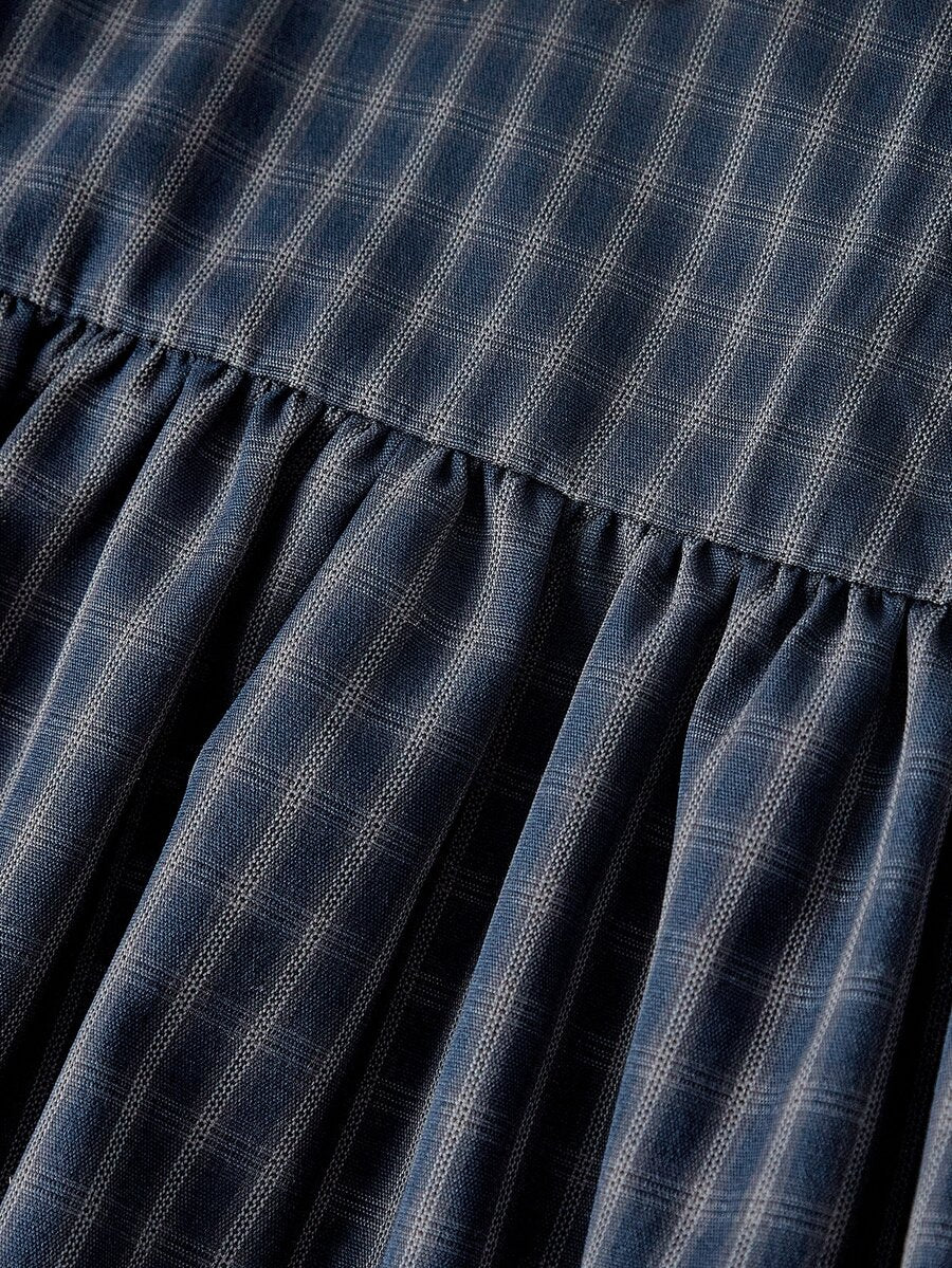 Women's plaid mini dress featuring a contrast lace Peter Pan collar, front bow accent, and short puff sleeves in a loose fit.