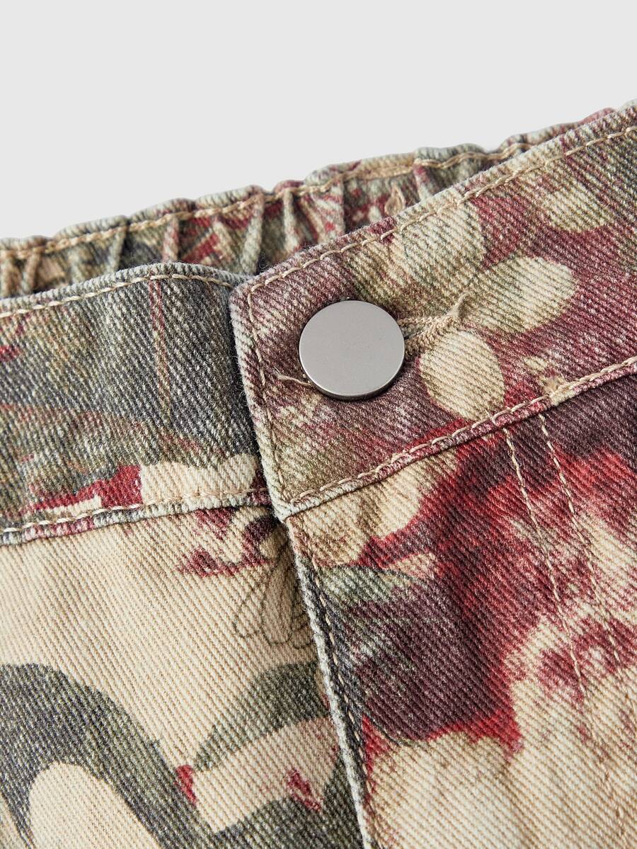 Women's loose wide-leg denim Bermuda shorts featuring vintage animal and paisley print with pockets and zipper fly.