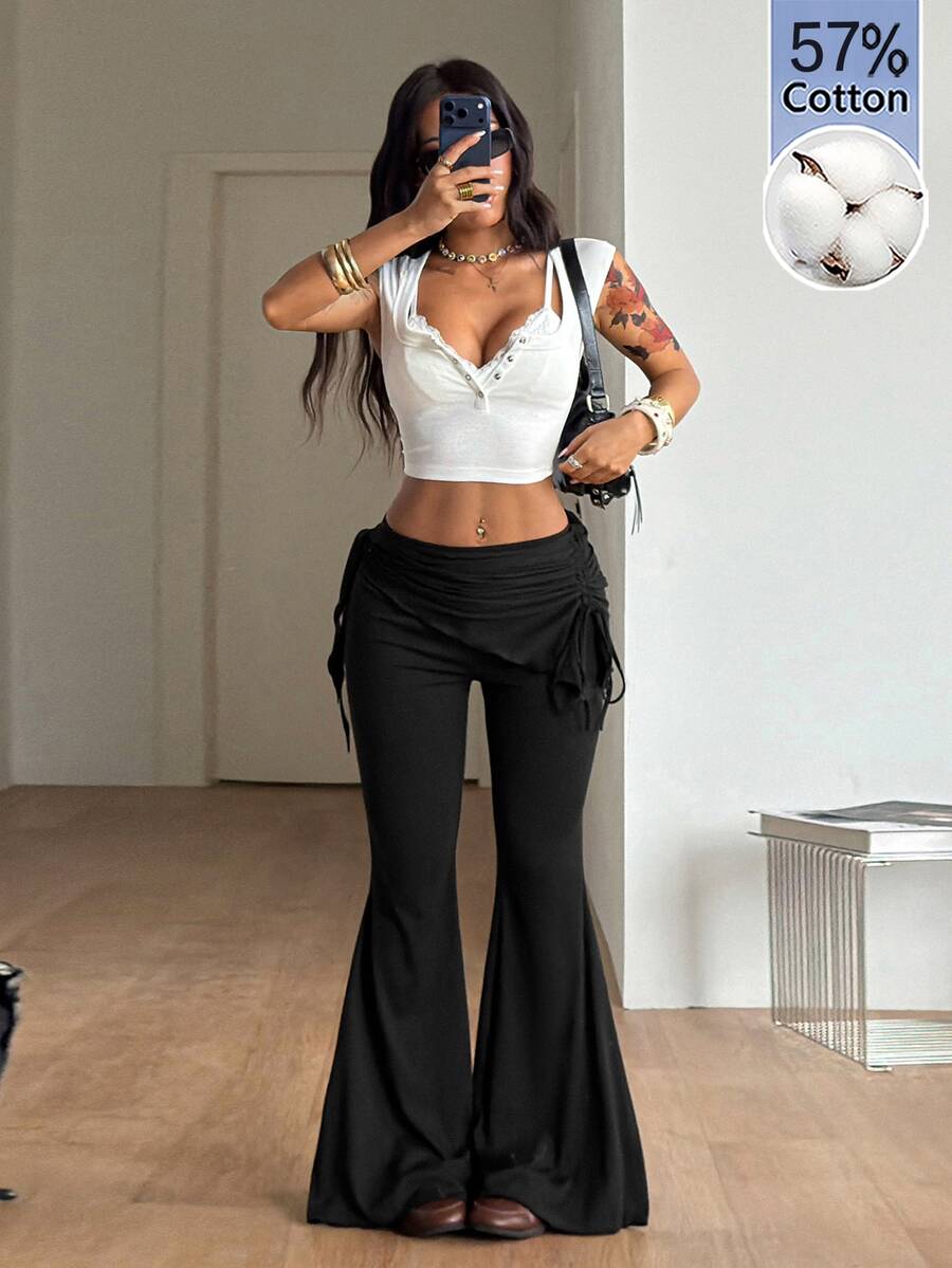 Women's black low rise flare pants with split hem detailing and stretchy knit fabric