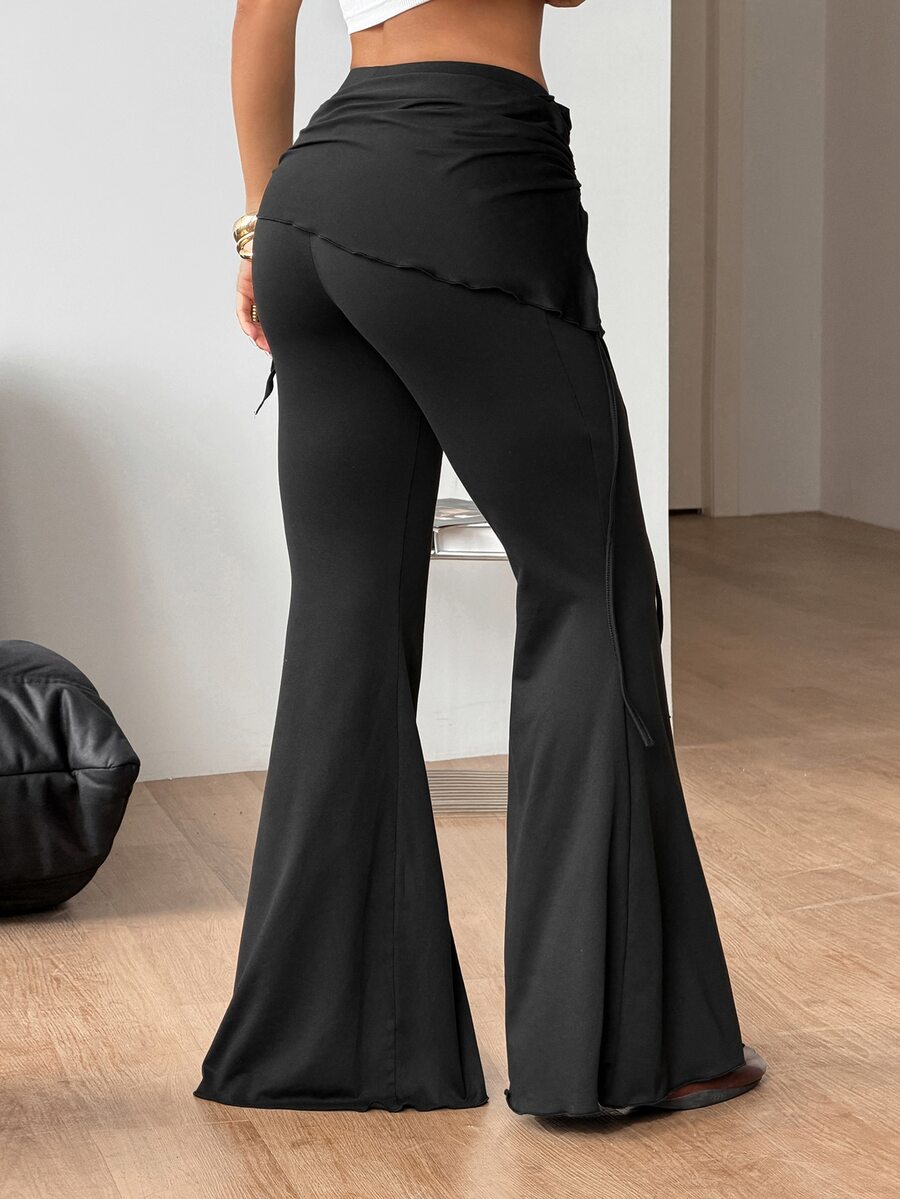 Women's black low rise flare pants with split hem detailing and stretchy knit fabric