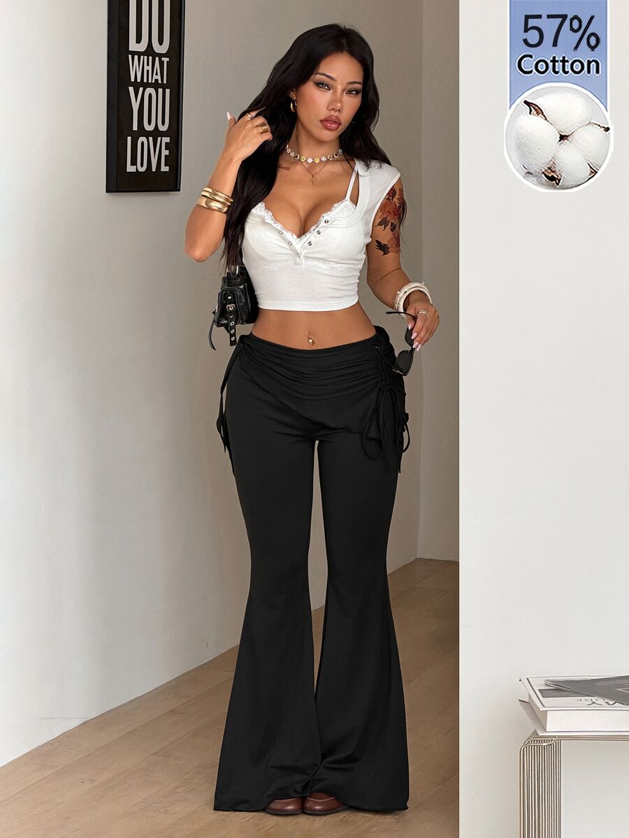 Women's black low rise flare pants with split hem detailing and stretchy knit fabric