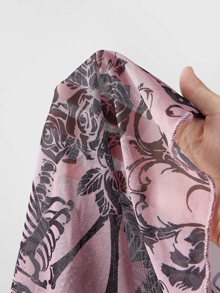 Women's sheer mesh slim fit top with allover vintage tattoo totem print, stand collar, and extra-long sleeves.