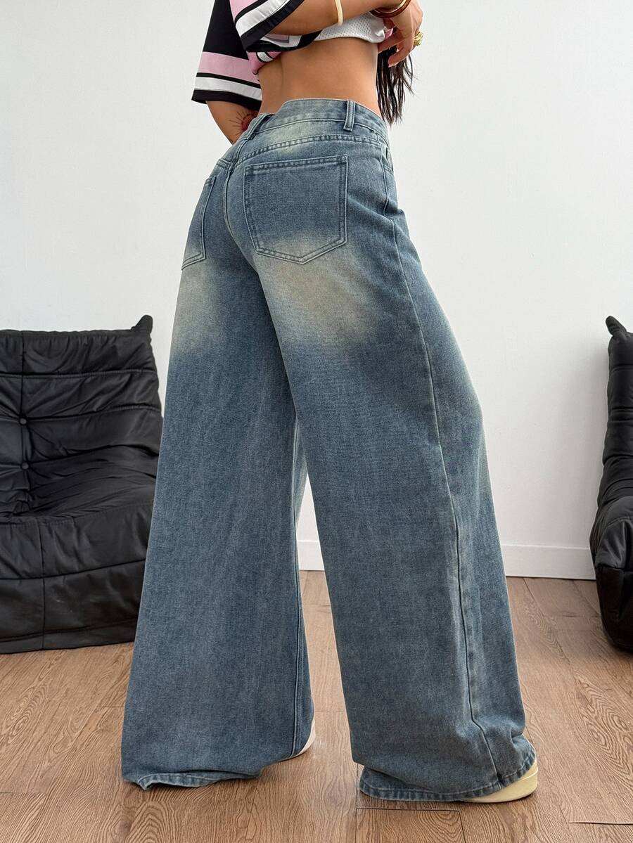 Loose wide leg denim jeans for women featuring a low waist, functional pockets, zipper fly closure, and extra long relaxed fit.