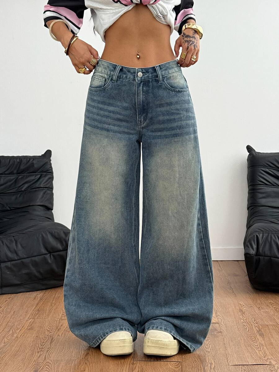 Loose wide leg denim jeans for women featuring a low waist, functional pockets, zipper fly closure, and extra long relaxed fit.