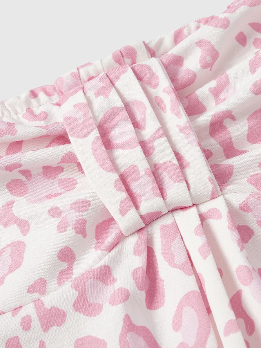 Women's striped strapless tube top featuring ruched detailing, flared hem, and stretchy knit fabric.