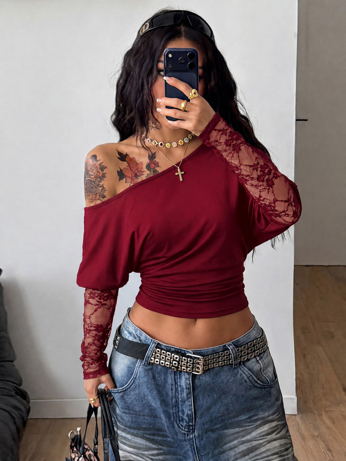 Women's black long sleeve t-shirt featuring delicate contrast lace details and a boat neckline in a knitted stretch fabric.