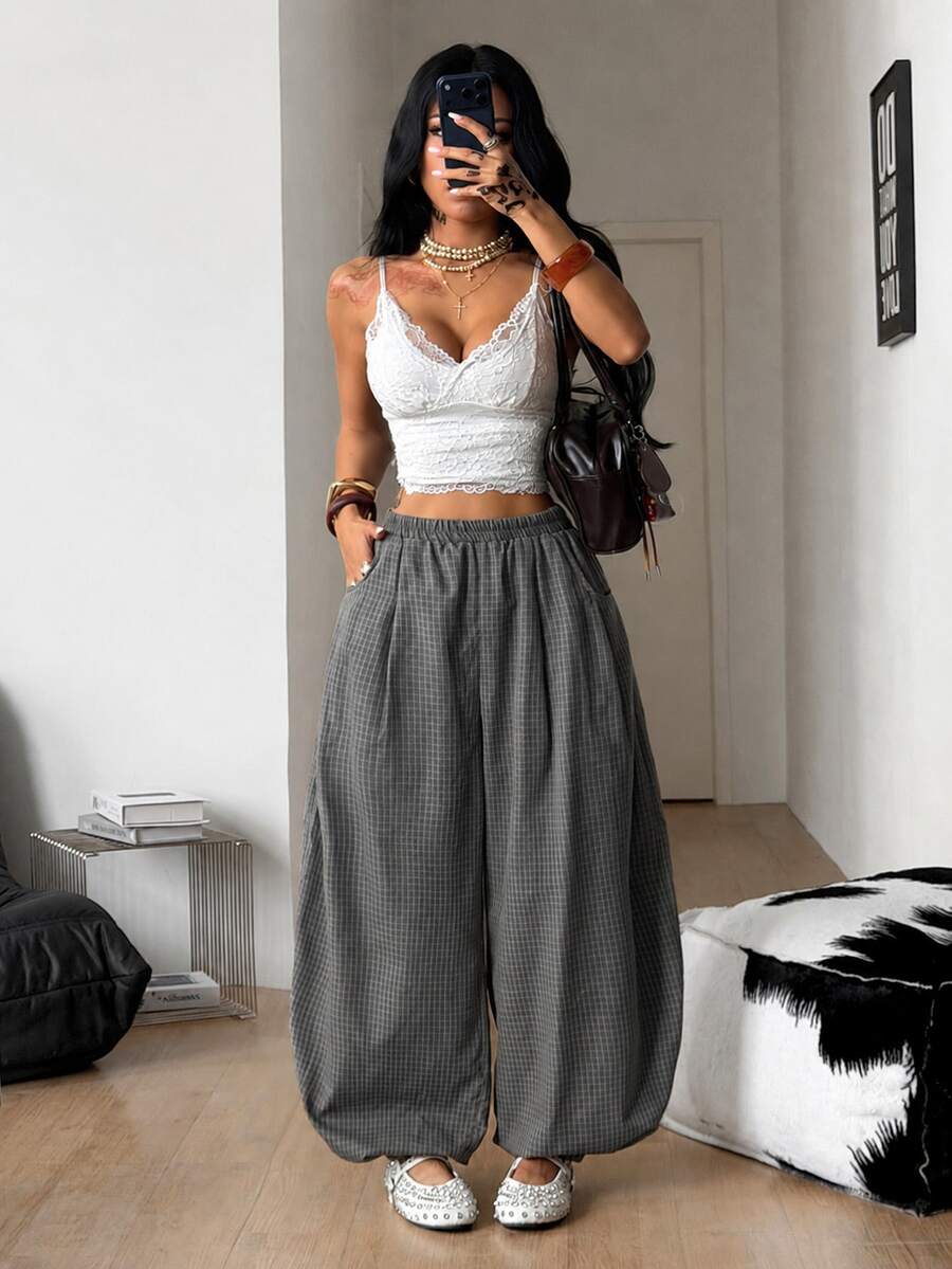 Women's loose-fit black bloomer pants made of 100% cotton featuring an elastic waistband and side pockets.