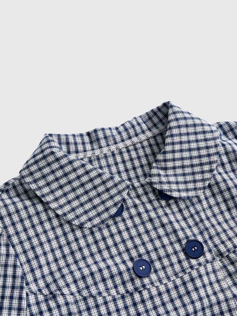 Women's short puff sleeve cotton blouse featuring a Peter Pan collar, double button detail, and front pocket.