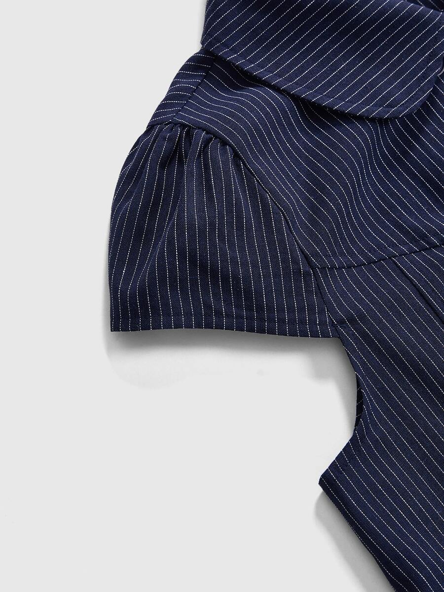 Women's short puff sleeve cotton blouse featuring a Peter Pan collar, double button detail, and front pocket.