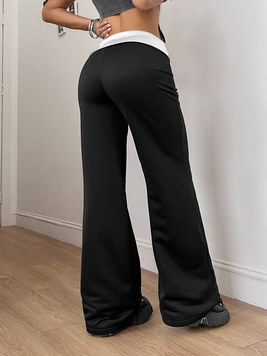 Women's black low waist wide leg flare sweatpants with rib-knit texture and contrast binding details.