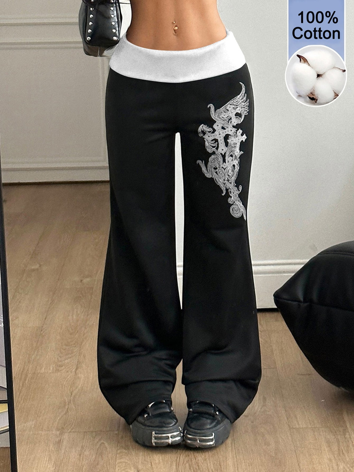 Women's black low waist wide leg flare sweatpants with rib-knit texture and contrast binding details.