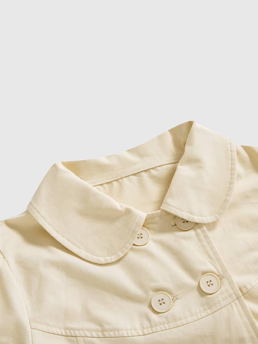 Women's short puff sleeve cotton blouse featuring a Peter Pan collar, double button detail, and front pocket.