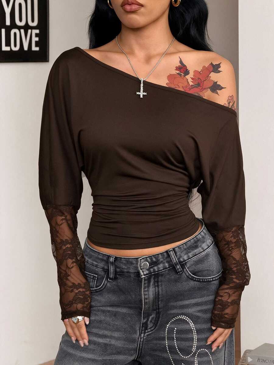 Women's black long sleeve t-shirt featuring delicate contrast lace details and a boat neckline in a knitted stretch fabric.
