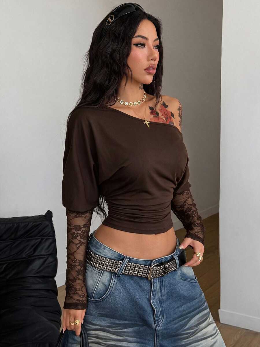 Women's black long sleeve t-shirt featuring delicate contrast lace details and a boat neckline in a knitted stretch fabric.